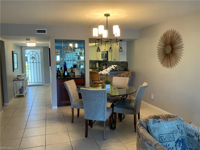 a living room with furniture a rug and a flat screen tv