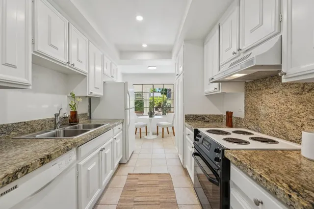 a kitchen with sink and cabinets