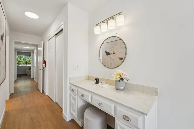 a bathroom with a sink vanity mirror and toilet