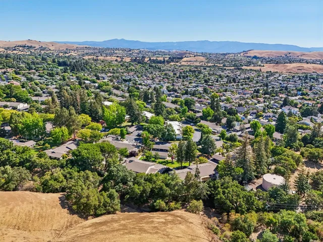 an aerial view of residential houses with outdoor space
