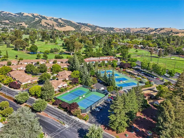 a view of a mountain range with lush green forest