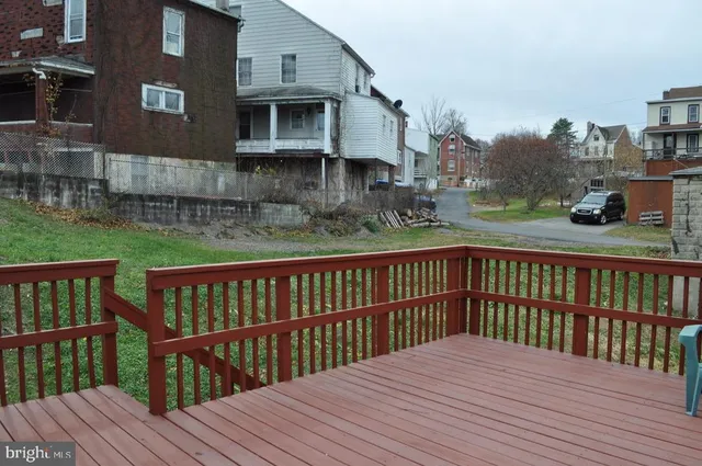 a view of a wooden deck and city view