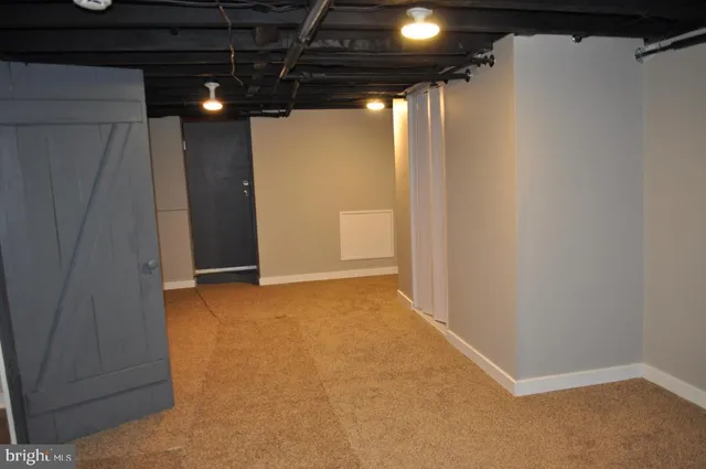 a view of a white house with a small yard and plants