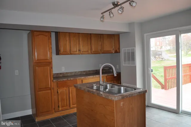 a kitchen with a refrigerator a sink and cabinets