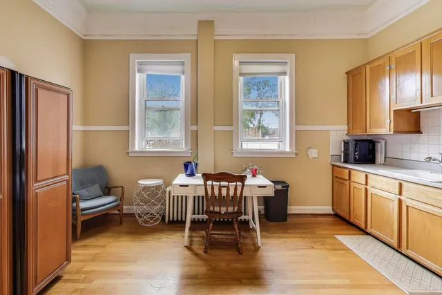a view of a room with wooden floor and windows