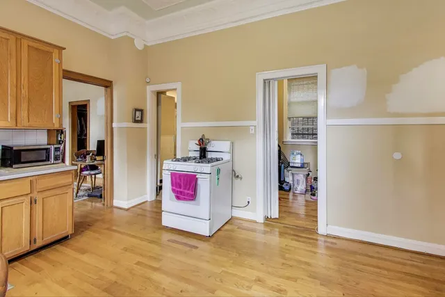 a view of a small space with wooden floor and a window