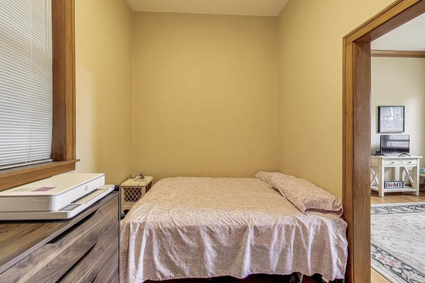3558 South Honore Street Chicago, IL 60609 - Photo 17 of 37 a bedroom with a bed and wooden floor