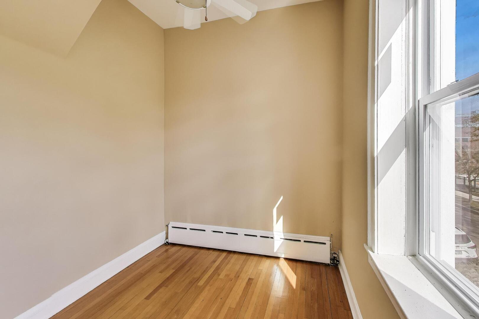 3558 South Honore Street Chicago, IL 60609 - Photo 31 of 37 a view of a room with wooden floor and a window