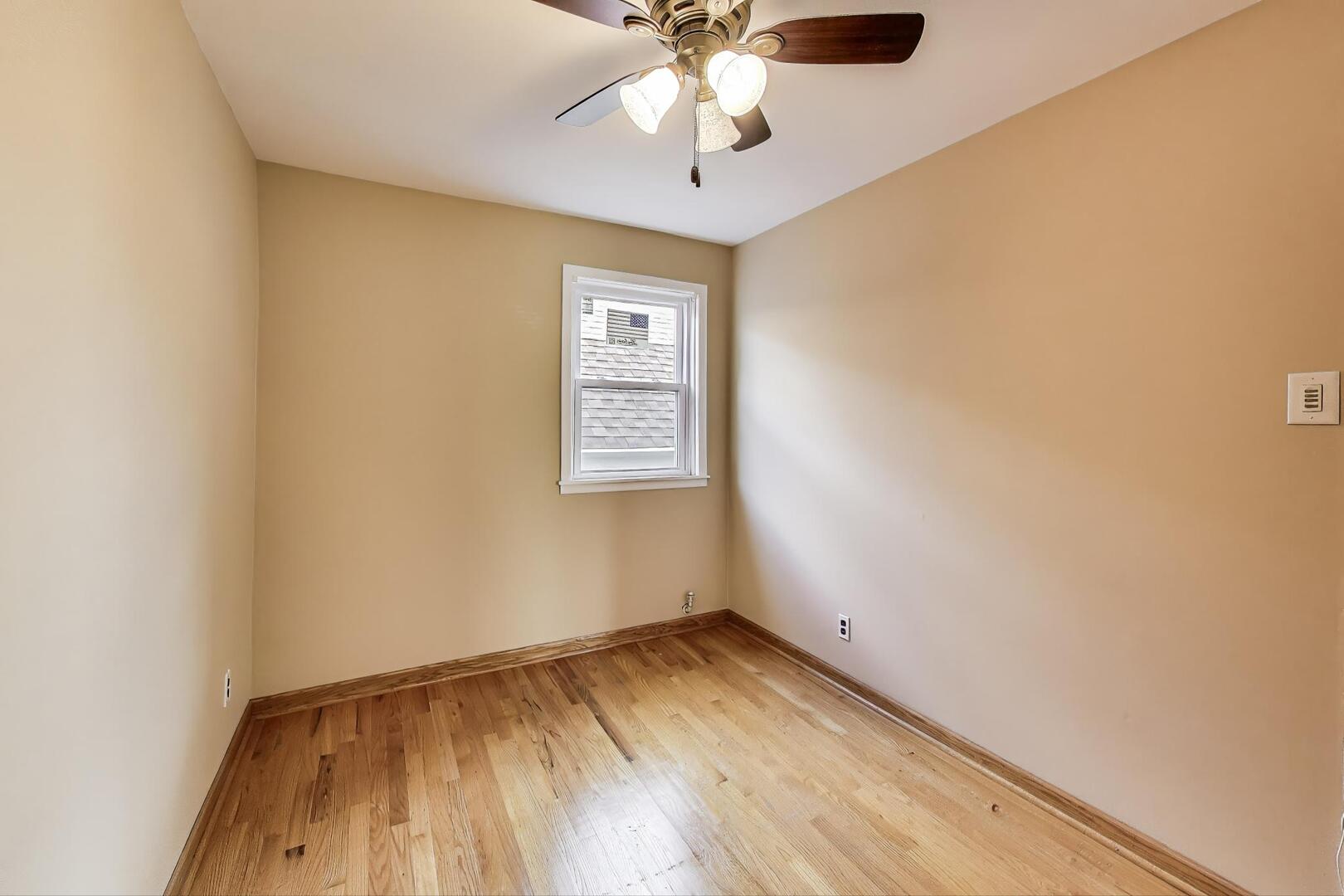 3558 South Honore Street Chicago, IL 60609 - Photo 32 of 37 an empty room with a window and ceiling fan