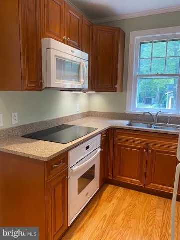 a kitchen with granite countertop cabinets stainless steel appliances and a sink