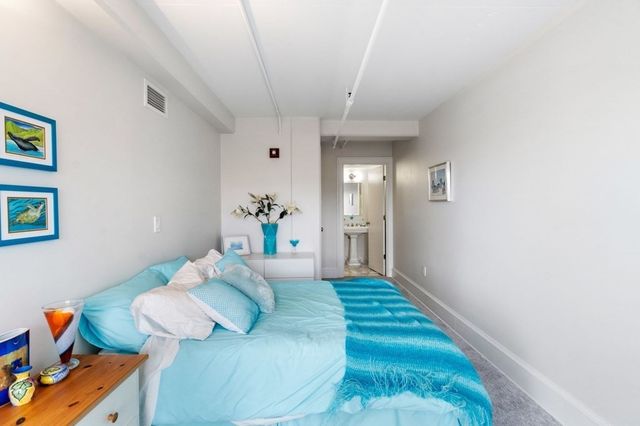 a living room with furniture and a baby crib