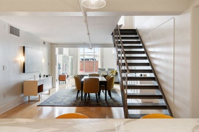 a view of entryway and hall with wooden floor
