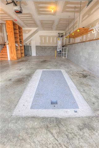 2022 Patrick Way Spring Hill, TN 37174 - Photo 13 of 14 2 CAR GARAGE - OWNERS INSTALLED STORM SHELTER TO KEEP SAFE! ALL ADDITIONAL SHELVING TO STAY