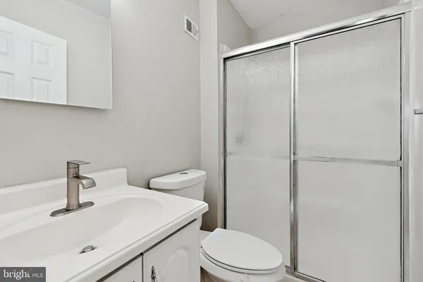 a white toilet sitting next to a bathroom sink