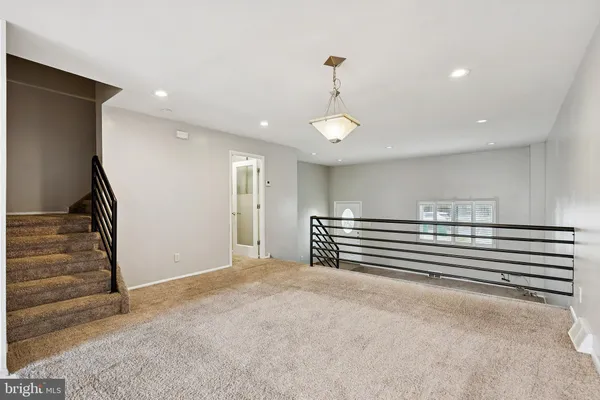 a kitchen with kitchen island a counter top space stainless steel appliances and cabinets