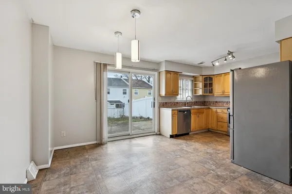 a kitchen with stainless steel appliances granite countertop a sink stove microwave and refrigerator