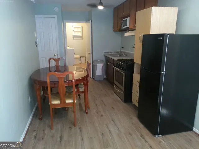 a kitchen with a table and refrigerator