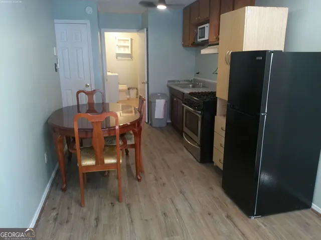 a dining room with furniture and wooden floor