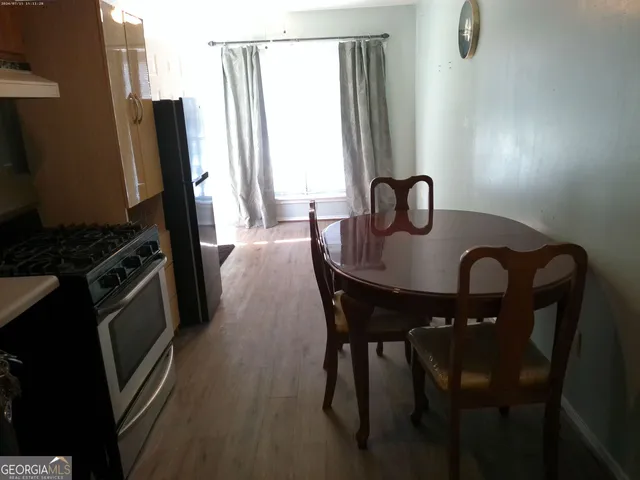 a dining room with furniture and a window