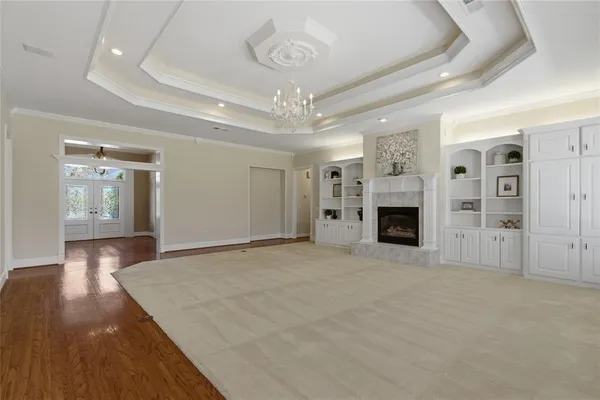 a view of a kitchen with cabinets and wooden floor