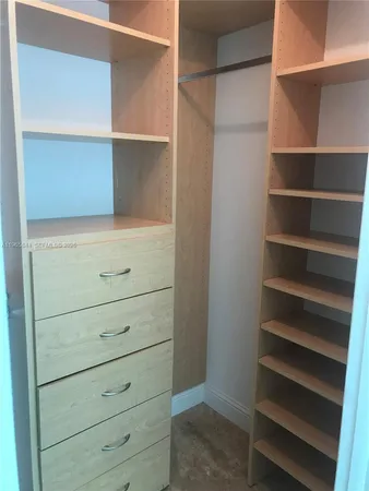 a bedroom with a bed and painting on the wall