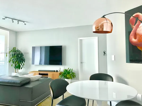 a living room with table and chairs