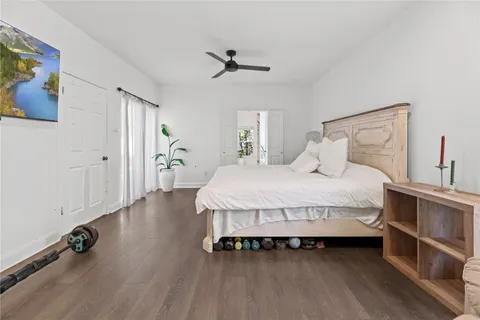a bedroom with a bed and wooden floor