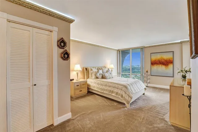 a spacious bedroom with a bed and a window