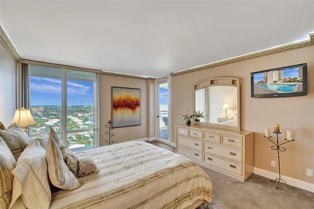 a bedroom with a bed and a dresser next to a window