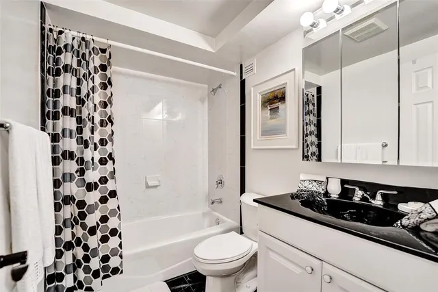 a bathroom with a sink a toilet a shower and a mirror