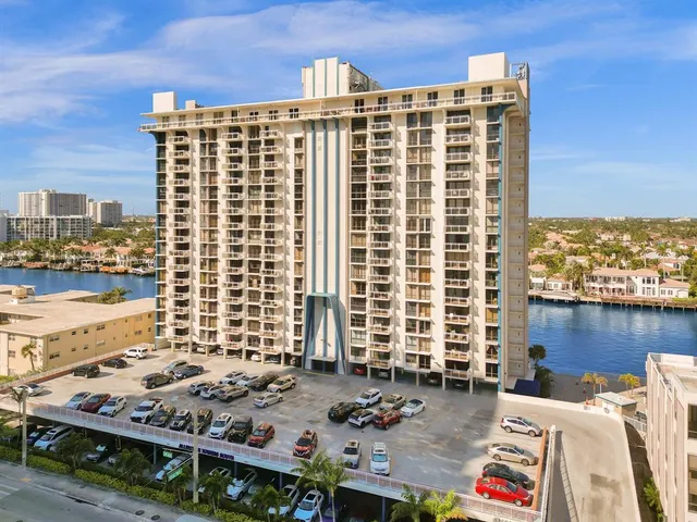 a view of a ocean with boats and trees in the background