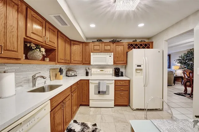 a kitchen with stainless steel appliances a refrigerator sink and cabinets