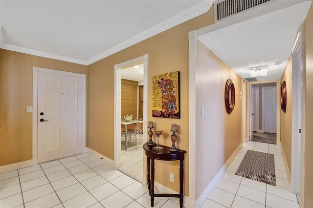 a view of a hallway and closet with living room
