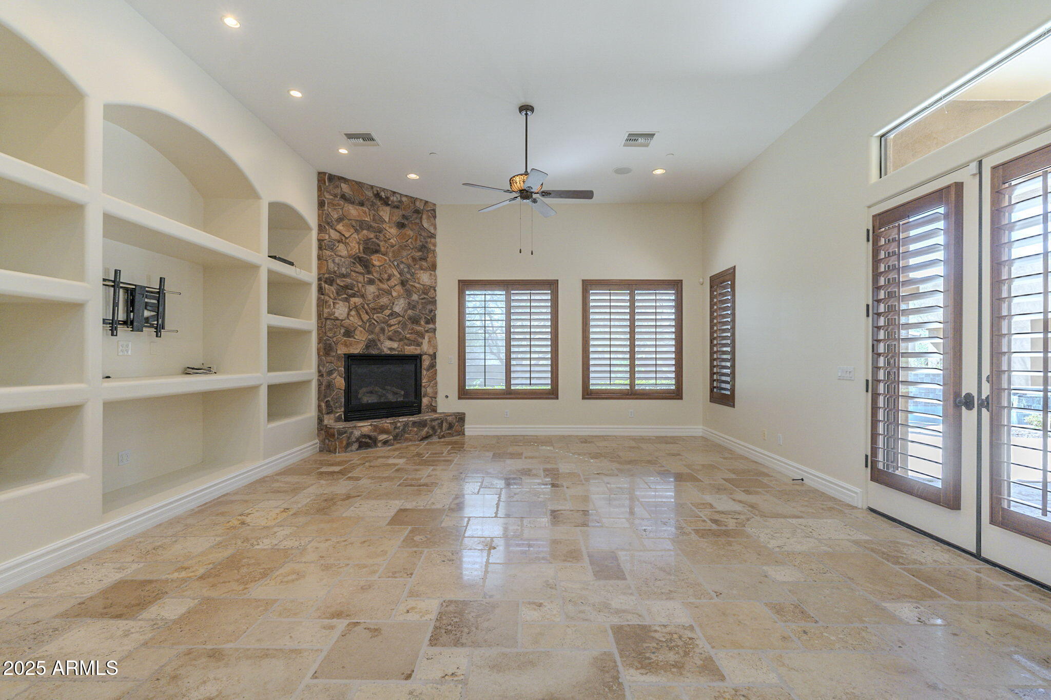 15135 East Monument Road Scottsdale, AZ 85262 - Photo 9 of 65 a view of an empty room with a fireplace and a window