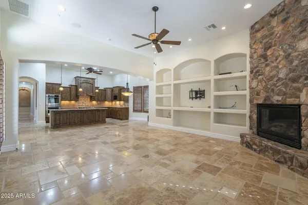 a kitchen with kitchen island granite countertop a stove and a sink
