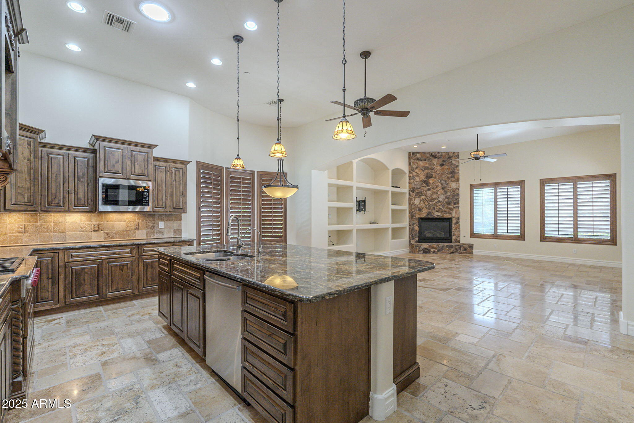 15135 East Monument Road Scottsdale, AZ 85262 - Photo 14 of 65 a kitchen with kitchen island granite countertop a stove and a sink