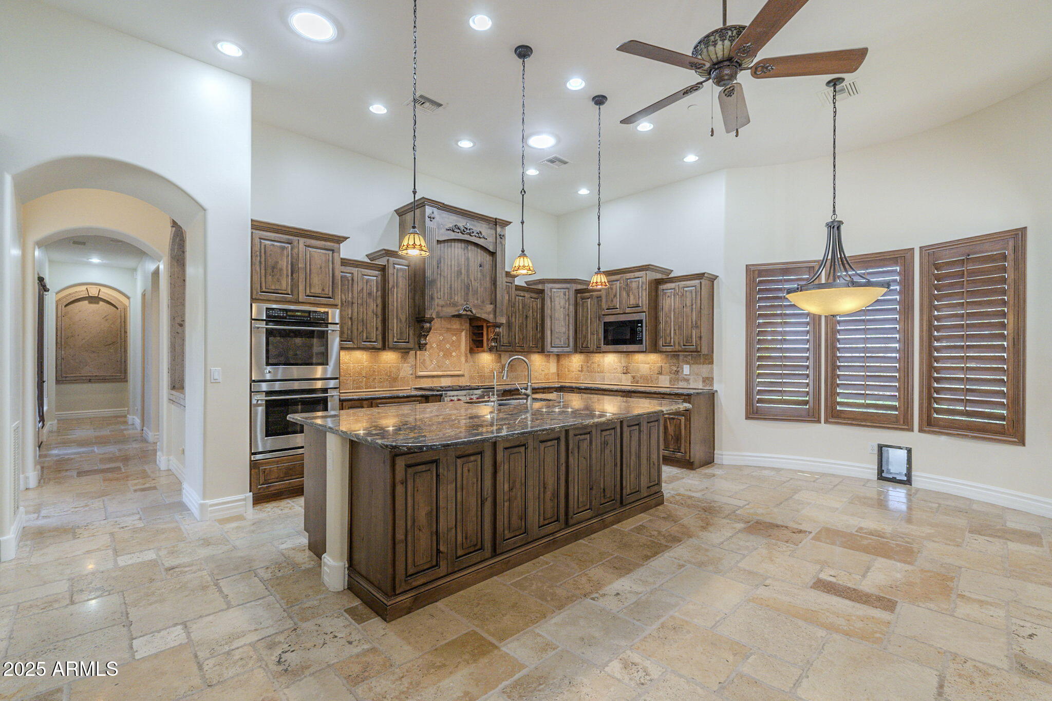 15135 East Monument Road Scottsdale, AZ 85262 - Photo 15 of 65 a large kitchen with a large counter top a sink stainless steel appliances and cabinets