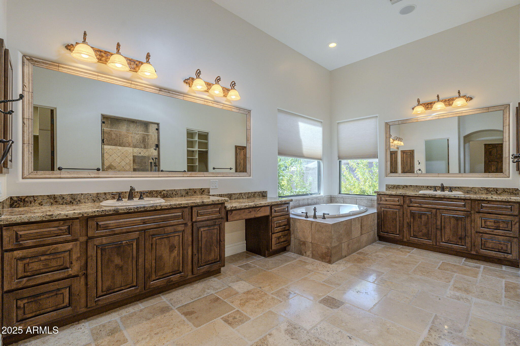 15135 East Monument Road Scottsdale, AZ 85262 - Photo 22 of 65 a bathroom with a tub a double vanity sink and mirror