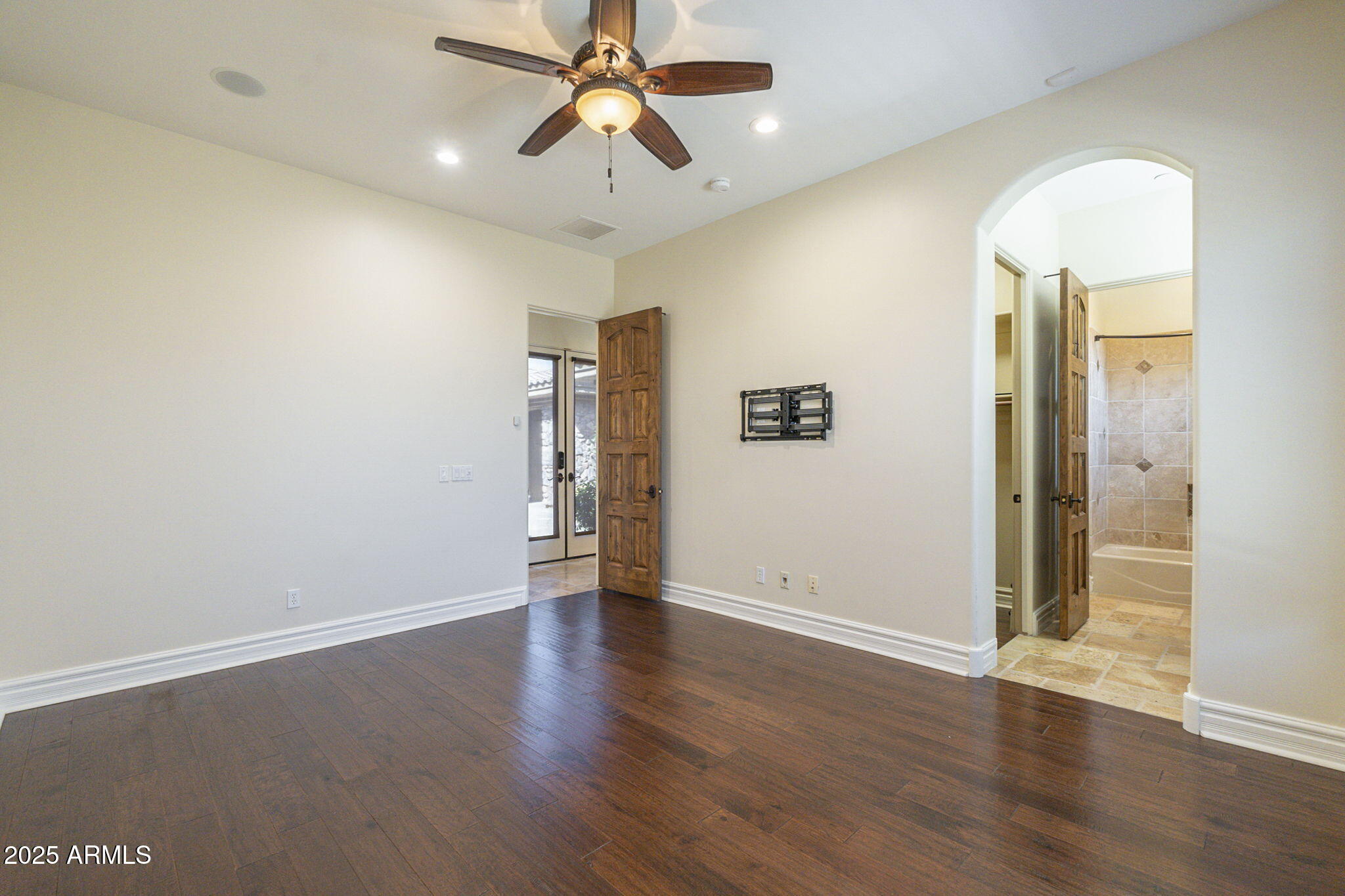 15135 East Monument Road Scottsdale, AZ 85262 - Photo 26 of 65 an empty room with wooden floor a ceiling fan and windows