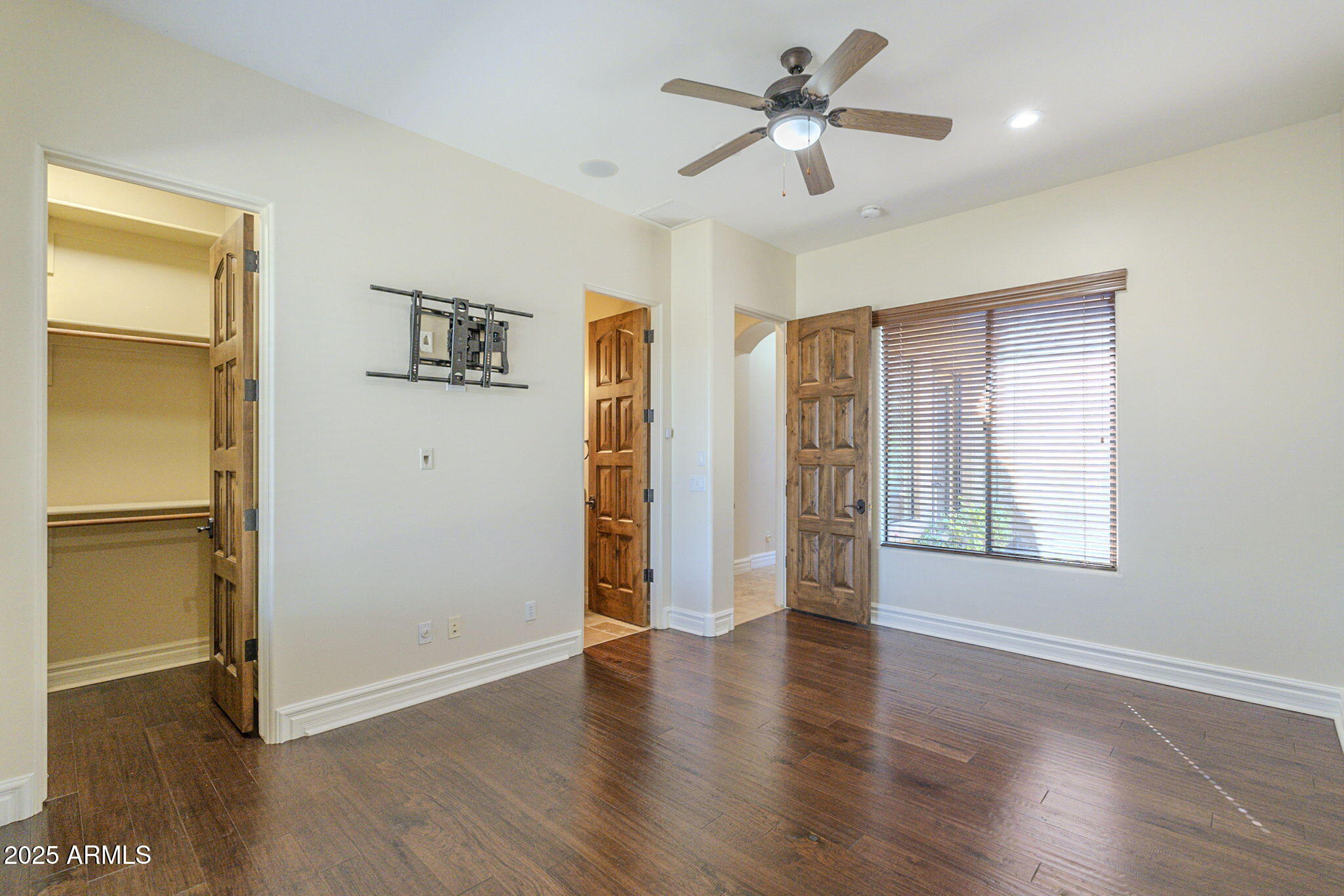 15135 East Monument Road Scottsdale, AZ 85262 - Photo 31 of 65 a view of an empty room with a window and wooden floor