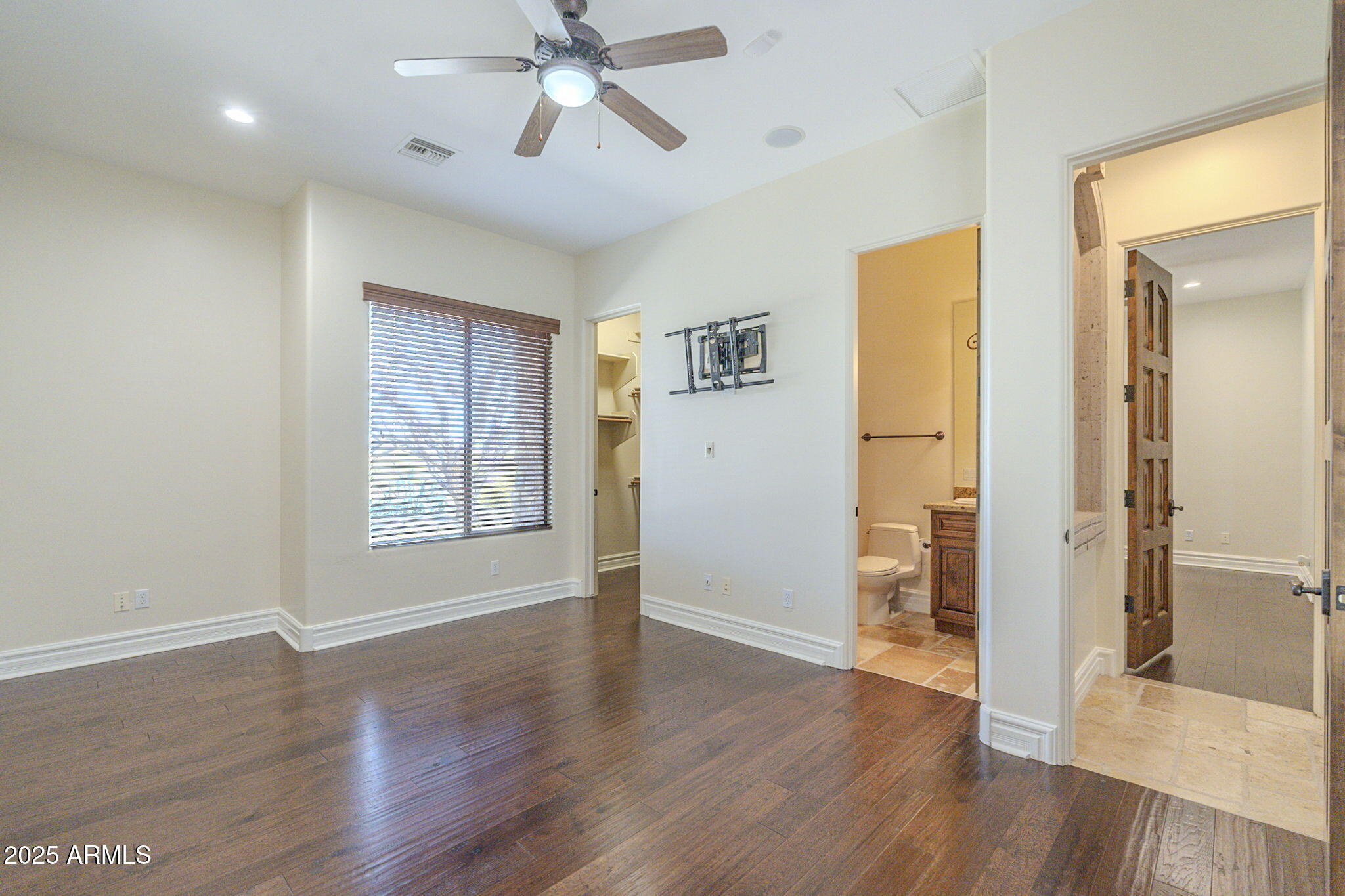 15135 East Monument Road Scottsdale, AZ 85262 - Photo 32 of 65 a view of an empty room with wooden floor and a window