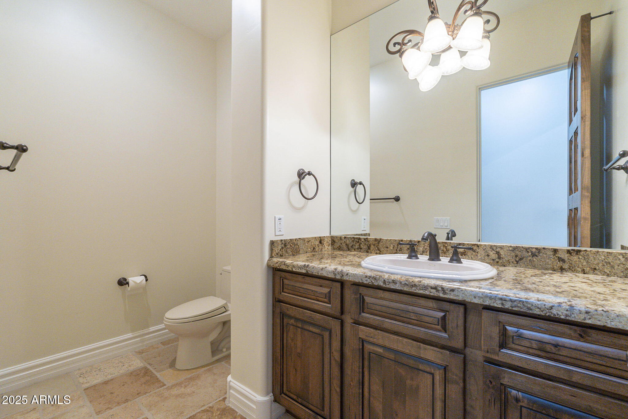 15135 East Monument Road Scottsdale, AZ 85262 - Photo 35 of 65 a bathroom with a granite countertop sink a toilet and a mirror