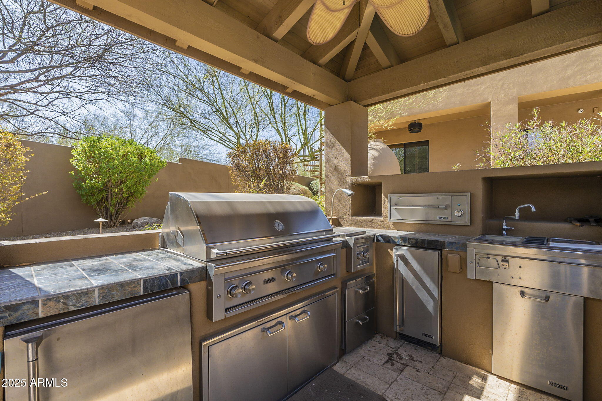 15135 East Monument Road Scottsdale, AZ 85262 - Photo 57 of 65 a kitchen with stainless steel appliances granite countertop a stove a sink and a microwave