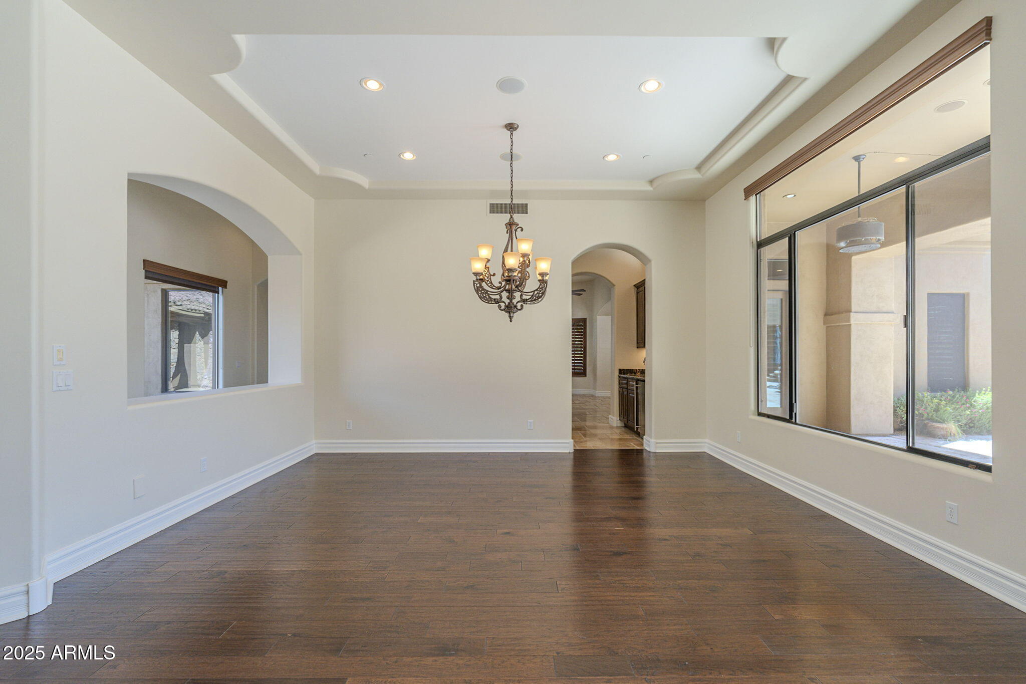 15135 East Monument Road Scottsdale, AZ 85262 - Photo 5 of 65 a view of an empty room with a window and wooden floor