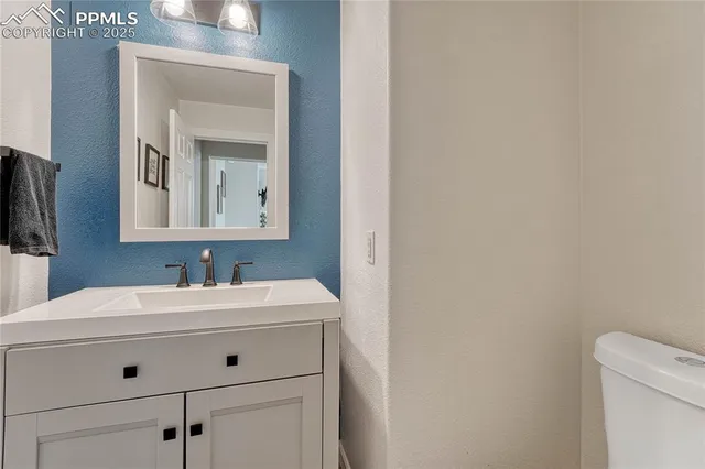 a kitchen with granite countertop a stove and a sink