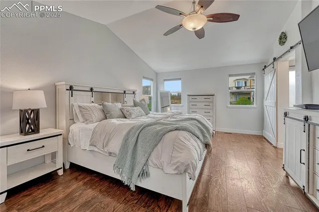 a kitchen with cabinets wooden floor and a ceiling fan
