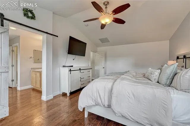 a view of a room with wooden floor and furniture