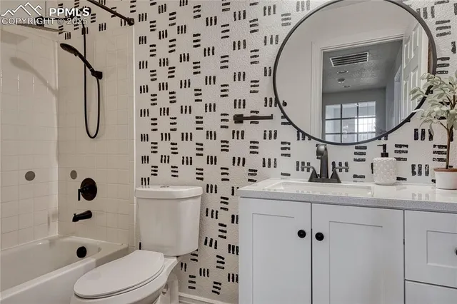 a bathroom with a double vanity sink toilet and shower