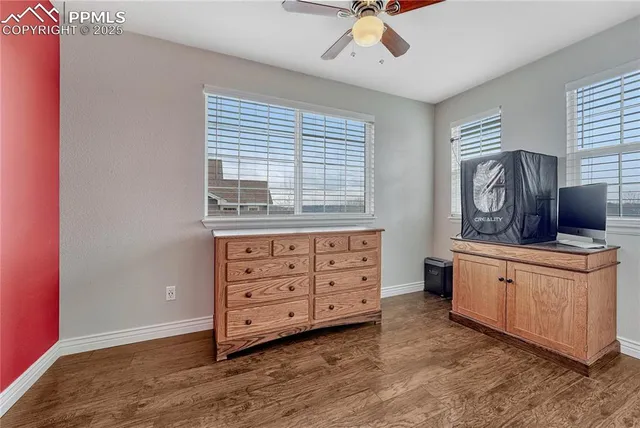 a spacious bedroom with a bed and a dresser