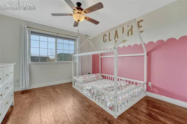 a living room with furniture and a ceiling fan